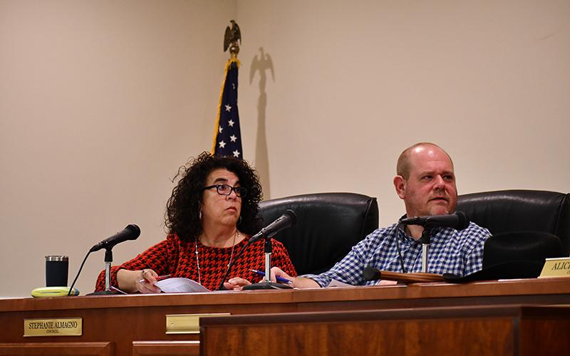 Baldwin Councilmembers Stephanie Almagno (left) and Erik Keith listen to a speaker during Monday’s meeting. JULIANNE AKERS/Staff