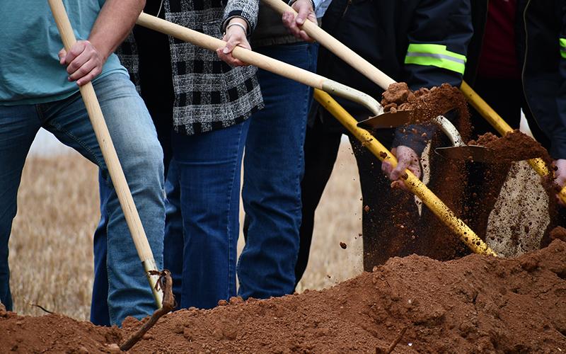 Dirt flies as public officials and workers dig in. JULIANNE AKERS/Staff
