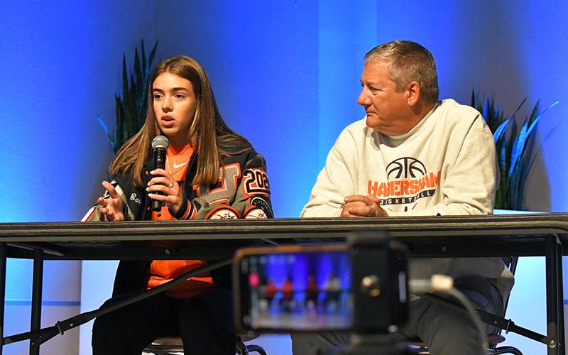 Habersham Central senior Kyia Barrett talks at Wednesday’s FCA Basketball Media Day at Free Chapel in Gainesville alongside Lady Raiders coach Bill Bradley. LANG STOREY/Staff