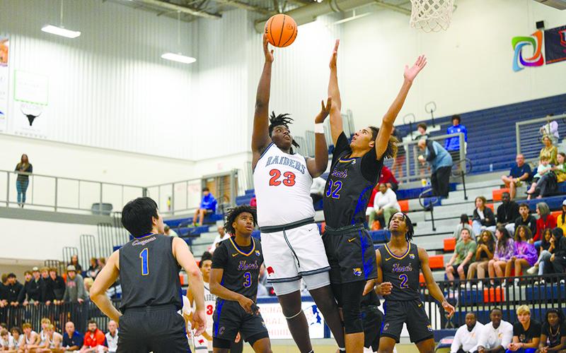 JoJo McCurry lands a hook shot over a defending Chattahoochee forward on Saturday night.  McCurry is a big part of the  Raiders’ plans to take a step forward this season. ZACH TAYLOR/Special
