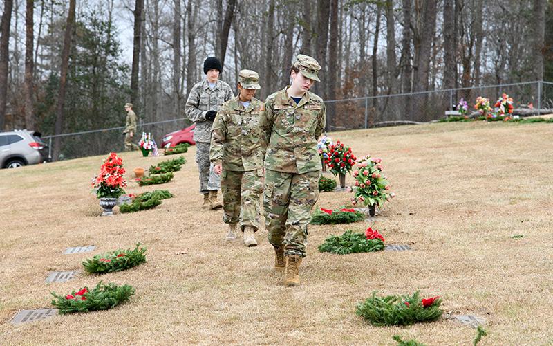 At Saturday’s Wreaths Across America ceremony at the VFW Memorial Park, Josslyn Webber, Zaelice Phasavang and Gabriel Morales ensure each veteran has a wreath placed on their headstone after the ceremony. ZACH TAYLOR/Special