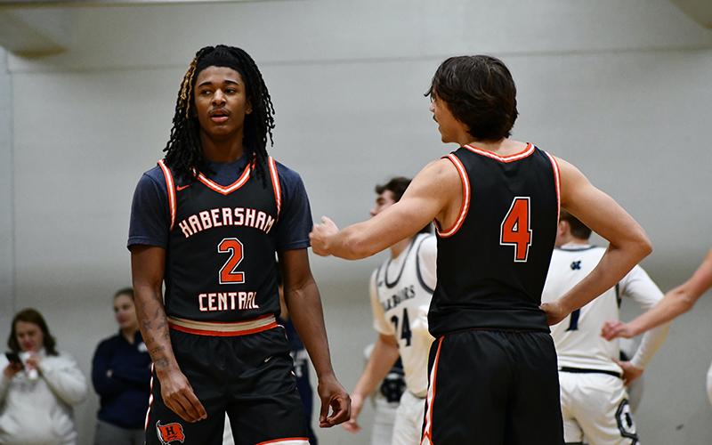 Raiders Enzo Combs (left) and Brannon Gaines talk things over after a foul during the White County game. LANG STOREY/Staff