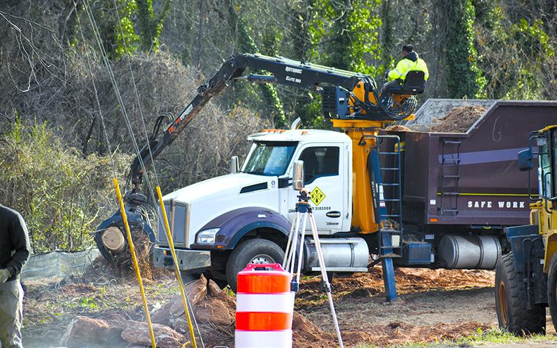 Workers undertake moving the sewer lines near the Johnny Mize Bridge in Demorest. MATTHEW OSBORNE/Staff