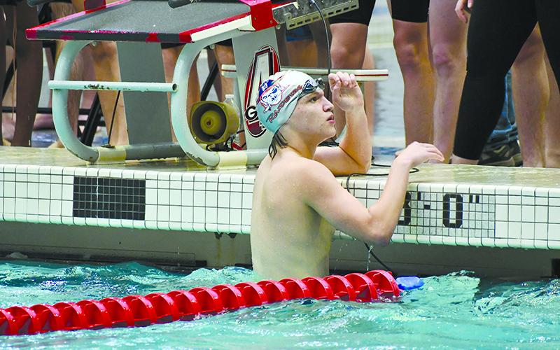 James Aguirre looks up at his time after finishing his heat Saturday. LANG STOREY/Staff