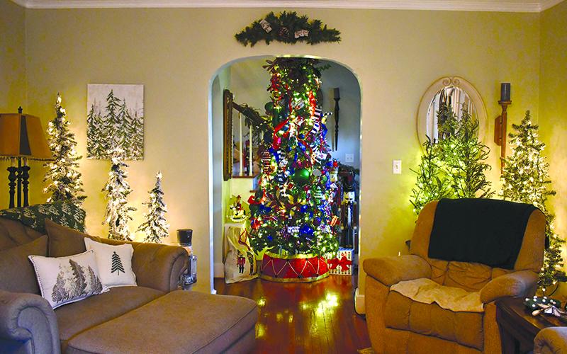 Teri Newsome’s Cornelia home is  as festive as can be, sporting 33  Christmas trees and plenty of  other holiday delights. JULIANNE AKERS/Staff
