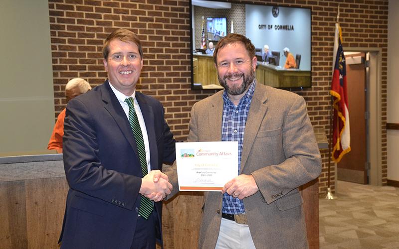 Cornelia Mayor John Borrow receives a certificate naming the city a PlanFirst Community for 2024-26 from Daniel Gaddis from the Department of Community Affairs. DONALD FRASER/Staff