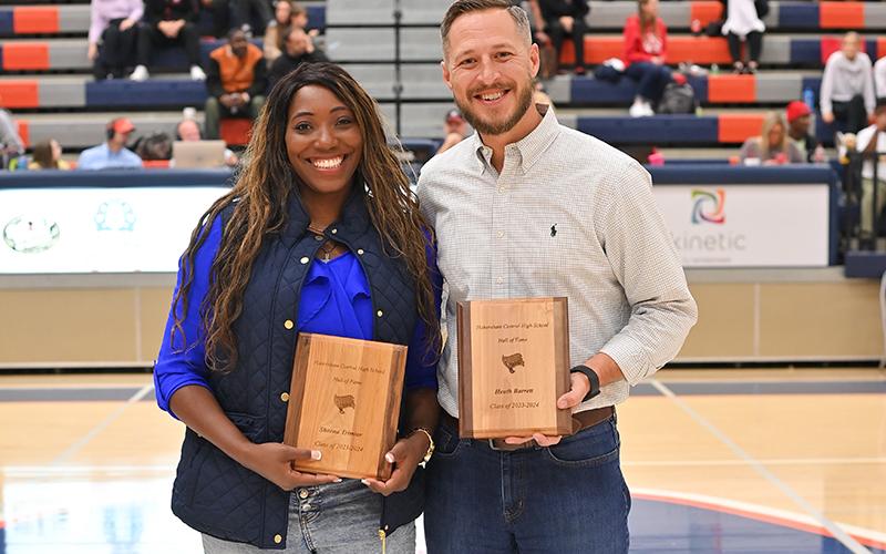 New Raider Basketball Hall of Fame inductees Sheena Trimiar and Heath Barrett meet on the court between games Friday night. TOM ASKEW/Special