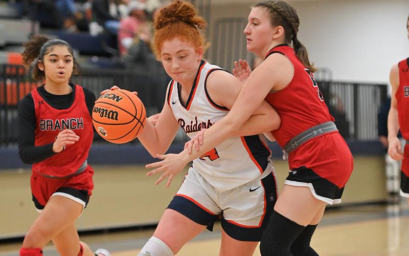 Habersham Central’s Daytona Underwood drives on a Flowery Branch defender on Friday night. Below, Kyia Barrett made her return to the lineup Friday night to help the Lady Raiders kickstart their season. TOM ASKEW/Special