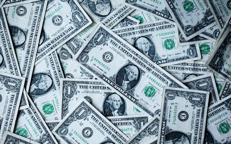 Photo of a pile of cash. Photo by Alexander Grey/Unsplash