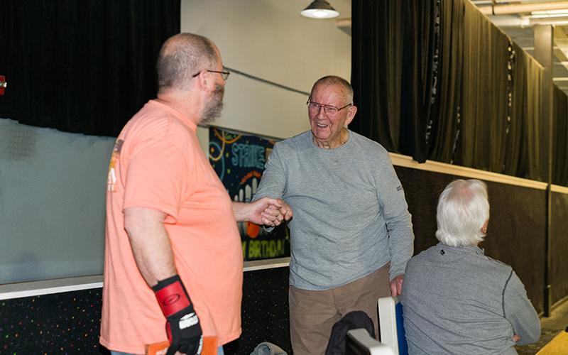 Richard Ames and John Maurer fist bump after Ames picked up the spare in Clarkesville on Monday night. ZACH TAYLOR/Special