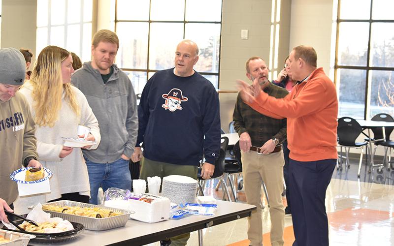 Habersham Central Principal Dr. Jonathan Stribling converses with Assistant Principal Donnie Bennett as teachers (from left) Jeff Wilson, Margaret Greenwald, Shane Hotalen and Matt Hudlow grab some breakfast at an appreciation meal put on by parents Tuesday morning at the school. MATTHEW OSBORNE/Staff