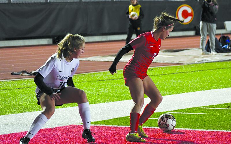 Habersham Central’s Addi Banks (left) battles Clarke Central’s Evin Carvell for possession near the penalty area on Monday night. LANG STOREY/Staff