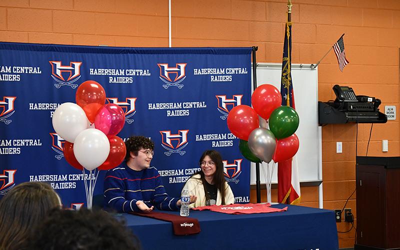 Habersham Central High School seniors Micah Zack and Kate Navarro share a laugh at Wednesday’s scholarship presentation. JULIANNE AKERS/Staff