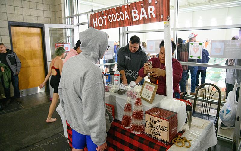 Jefferson swimmer Will Nunnally gets some hot chocolate before his heat in the 2024 Hot Chocolate Meet hosted by Habersham. ZACH TAYLOR/Special