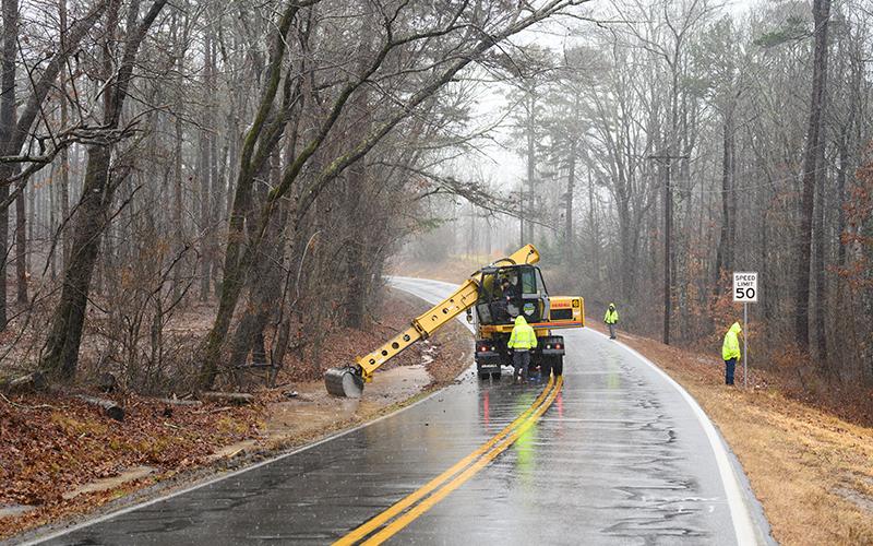 Habersham County Road Department crews work to settle a clogged culvert on New Liberty Rd. The clogged culvert sent floodwaters over the road, preventing safe travel. ZACH TAYLOR/Special