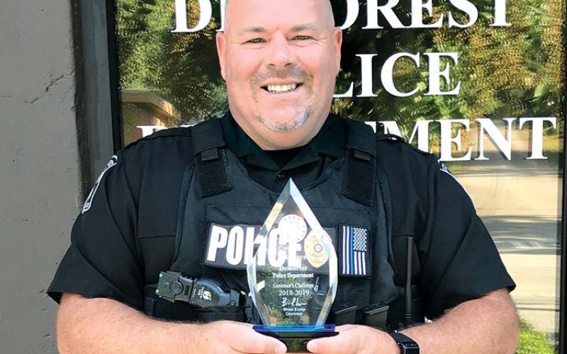 Former Demorest Police Chief Robin Krockum shows off the department’s award for best highway safety in the state in 2018-19. FILE