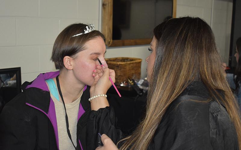 Ashley Davis gets her makeup just right before getting ready to dance at A Night to Shine. MATTHEW OSBORNE/Staff