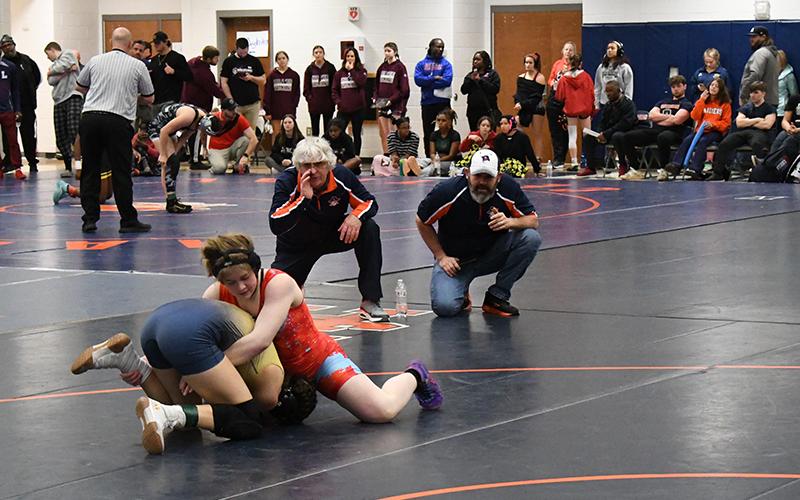 Habersham Central coaches Morris Brooks and Len King instruct McKenzie Spradley at the state sectional meet Friday. LANG STOREY/Staff
