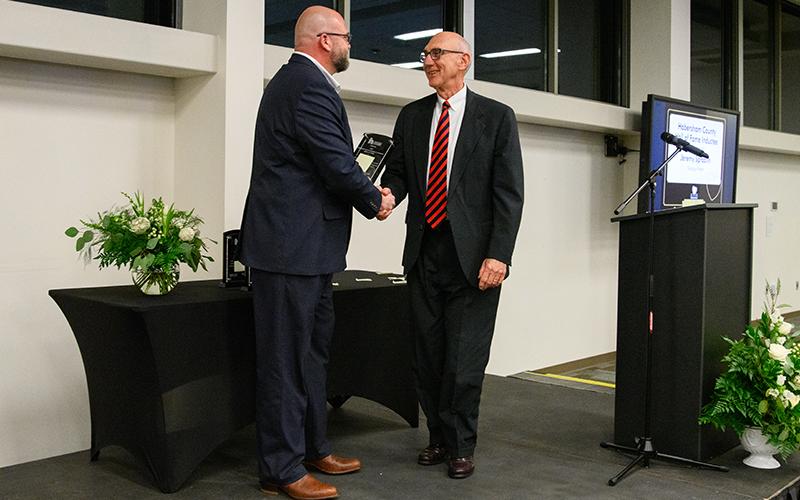 Jeremy Spradlin (left) shakes hands with Habersham County Hall of Fame Inductee Rope Roberts at the Chamber of Commerce Gala on Feb. 8. ZACH TAYLOR/Special