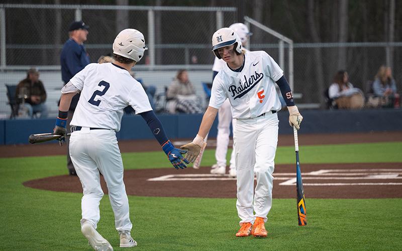 After touching home plate, Maverick Chitwood low-fives Raiders catcher Spencer Frady on the way to the dugout in an earlier win over Elbert County. ZACH TAYLOR/Special