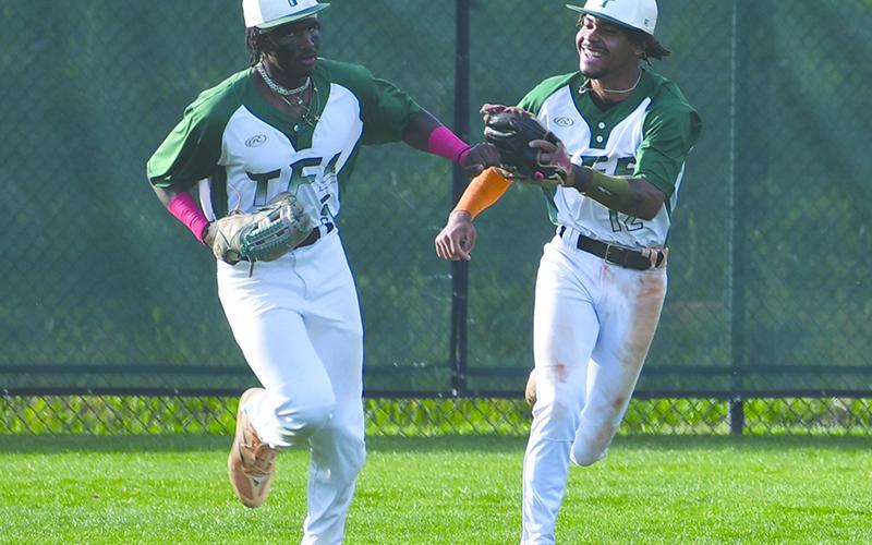 Tallulah Falls’ Danny Grant and BJ Carver dap each other up after an inning-ending catch by the former.