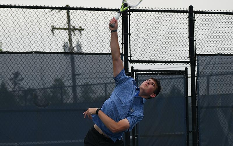 Habersham’s Josh Burris slams a serve in Wednesday’s state match against Newnan. LANG STOREY/Staff