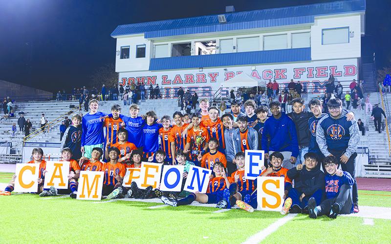 Habersham Central boys soccer players celebrate their region title with fellow students and friends Tuesday night after knocking off North Forsyth 1-0 to clinch first place. LANG STOREY/Staff