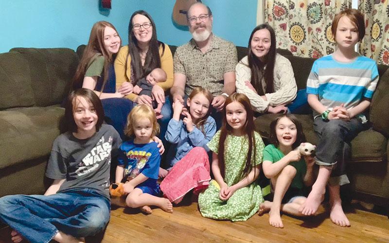 Randy and Mackenzie Chester are shown with their nine children Rosie, Paloma, Kells, Remy, Heidi, Azalea, Rune, Haven and Ezra.