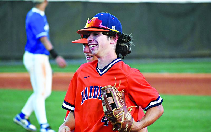 Kreed Barrett shares a moment with teammates between innings. Barrett made a sensational over-the-wall snag in left field Wednesday night. LANG STOREY/Staff