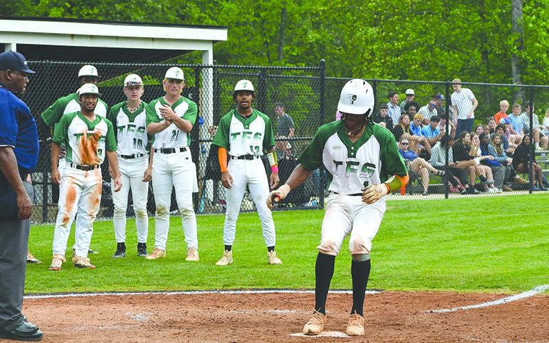 Caden Walker steps on the plate after hitting a home run Saturday in Game 1 of the series. LANG STOREY/Staff