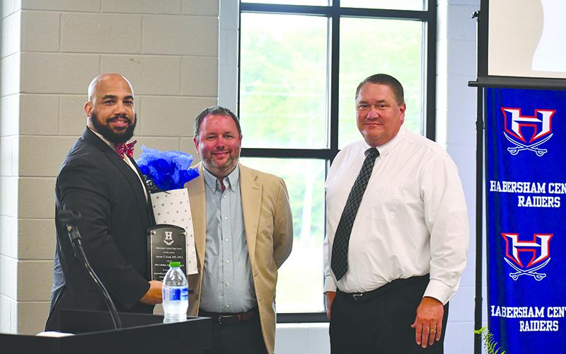 From left, Dr. Aaron Scott, Habersham Schools Assistant Superintendent Patrick Franklin and Board of Education member Doug Westmoreland present Scott with a plaque for the 2024 Lifetime Achievement Award. JULIANNE AKERS/Staff