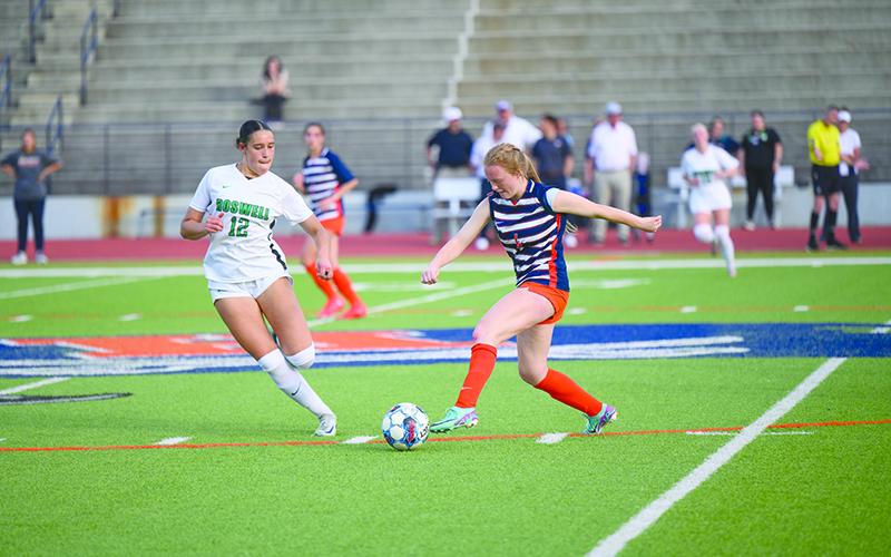 Habersham Central’s Annabelle Clark dribbles around the Roswell midfielder in the Sweet 16 game Thursday night. ZACH TAYLOR/Special