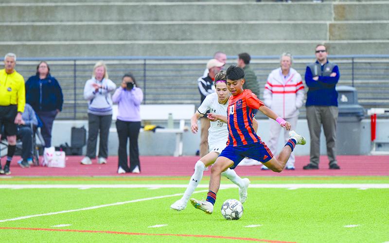 Raiders senior Juan Lara boots the soccer ball down the pitch in hopes of a scoring opportunity against Sprayberry. ZACH TAYLOR/Special