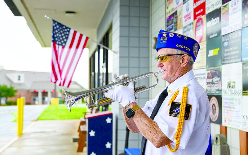 Danny Stephens plays Taps and Amazing Grace on the trumpet during the Grant-Reeves VFW Post 7720 Memorial Day service, which had to move inside due to inclement weather Monday morning. But the bad weather did not stop veterans from paying respects to those who have given their lives for freedom. ZACH TAYLOR/Special
