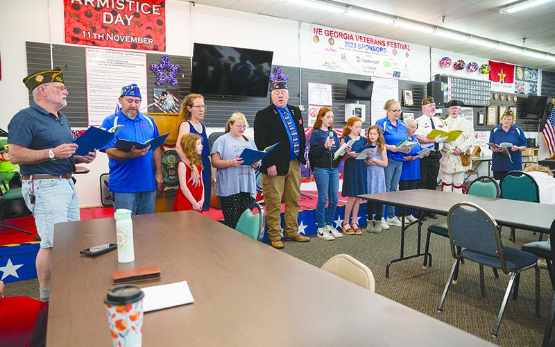 The Grant Reeves Singers sing the National Anthem before the ceremony begins. ZACH TAYLOR/Special