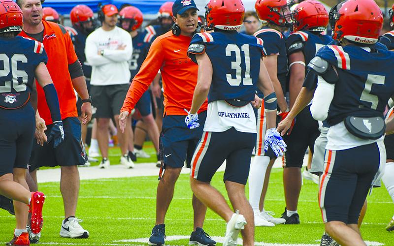 Habersham assistant coach Isaiah Murphy hypes up Luke Chastain (31) after a play Friday. LANG STOREY/Staff