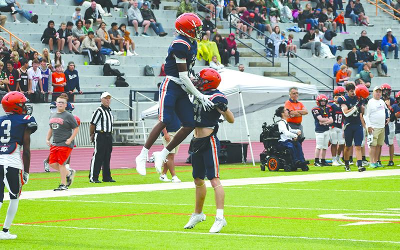 Habersham’s Jay Feltus gets some air while celebrating with Landyn Savage. LANG STOREY/Staff