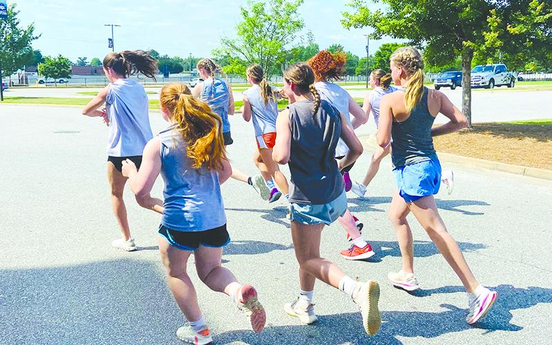 Members of the HCHS girls basketball team run during the team’s Couch Potato 5K Wednesday. SUBMITTED
