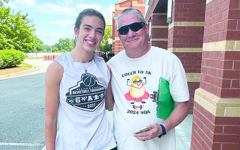 Graduating senior Kyia Barrett, pictured alongside Lady Raiders coach Bill Bradley, ran in the 5K Wednesday. SUBMITTED