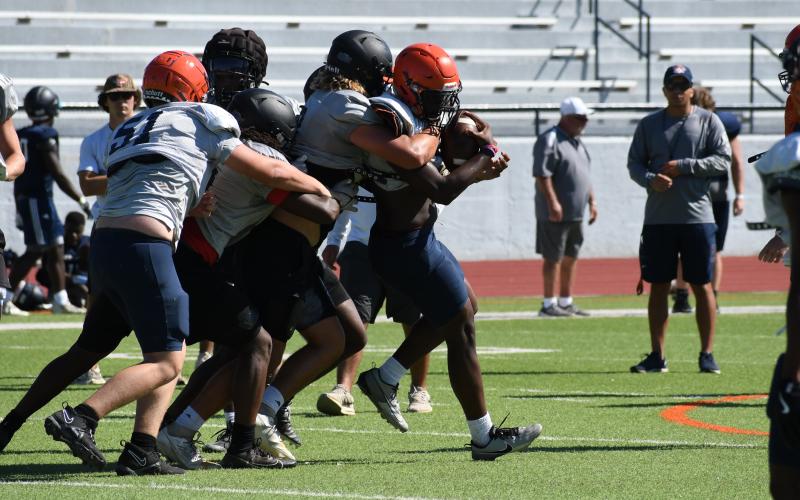 Raider ballcarrier Antonio Cantrell is met at the line of scrimmage by a bevy of Morgan County defenders. LANG STOREY/Staff
