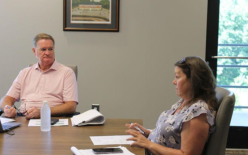 Pilot Michelle Curcio (right) talks to the Airport Commission on Tuesday as County CFO Tim Sims listens.
