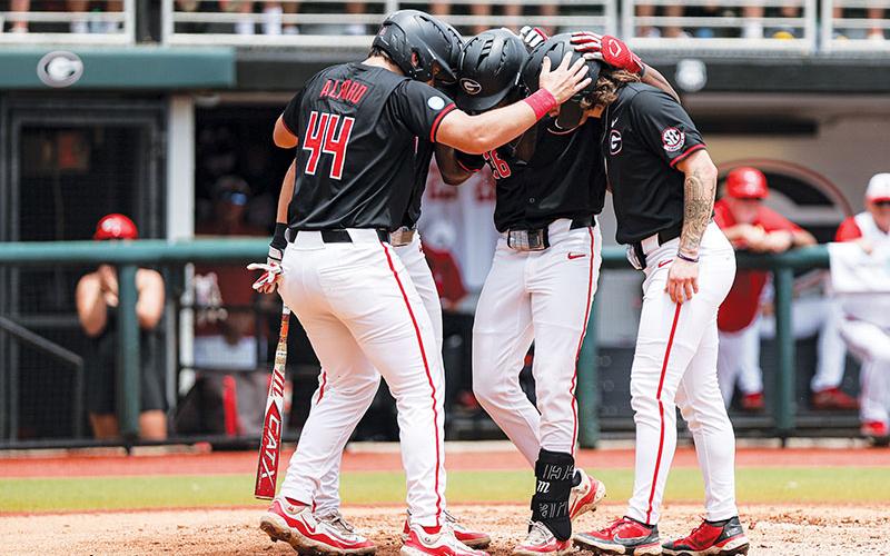 Georgia’s Slate Alford, Tre Phelps and Paul Toetz celebrate during Sunday’s Game 2 win. KARI HODGES/UGAAA