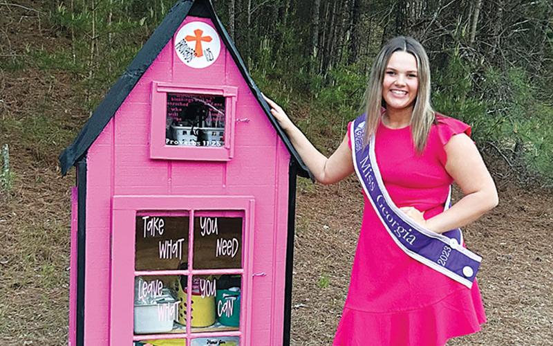 Ansleigh Sherlin stands next to her newly installed blessing box at Little Dreamers Academy in Cornelia.