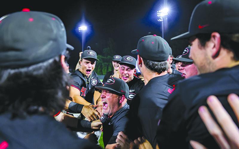 Georgia Head Coach Wes Johnson celebrates with his team after the Bulldogs advanced to the NCAA Super Regionals Sunday night. KARI HODGES/UGAAA