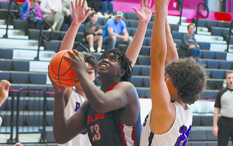 Josiah McCurry gets surrounded by defenders during a game last year. He will get plenty of attention from colleges during his senior year. FILE