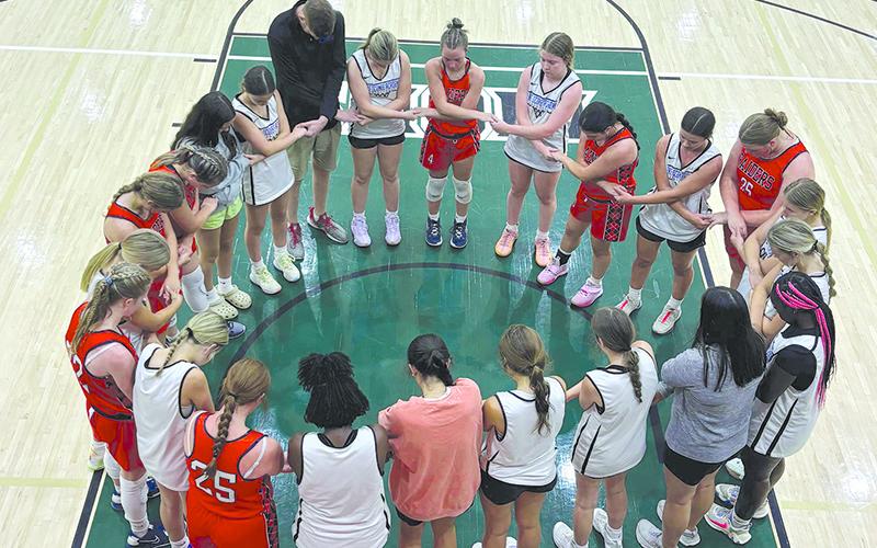A group of hoopsters, including several Lady Raiders, break off into a prayer circle during Piedmont’s FCA camp last weekend. KIM BRADLEY/Submitted