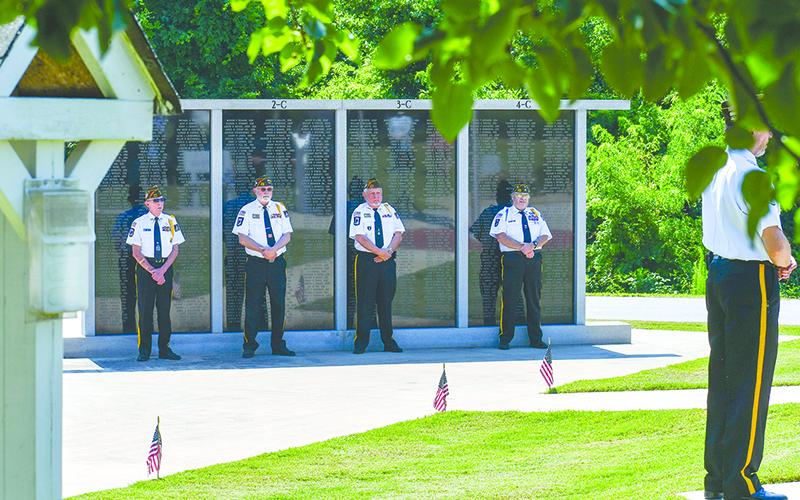 Grant Reeves VFW Honor Guard members stand in front of the Habersham County Wall of Honor in Cornelia on Flag Day, June 14. From left are Bill McAllister, Roy Albea, Barry Church and David Squires. JULIANNE AKERS/Staff