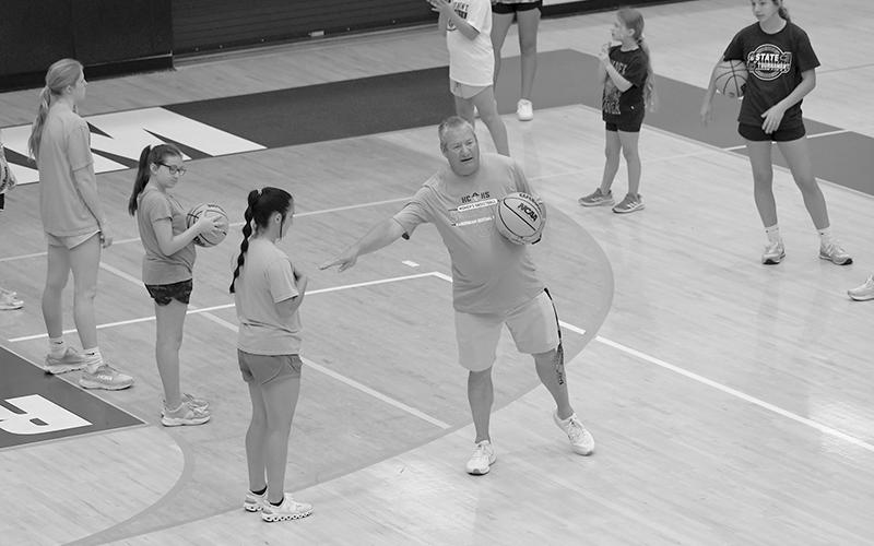 HCHS Coach Bill Bradley instructs campers ahead of a drill at basketball camp this week. LANG STOREY/Staff