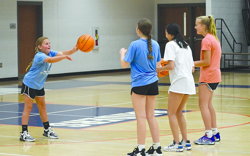 Breelynn Dover works on a passing drill with fellow campers. LANG STOREY/Staff