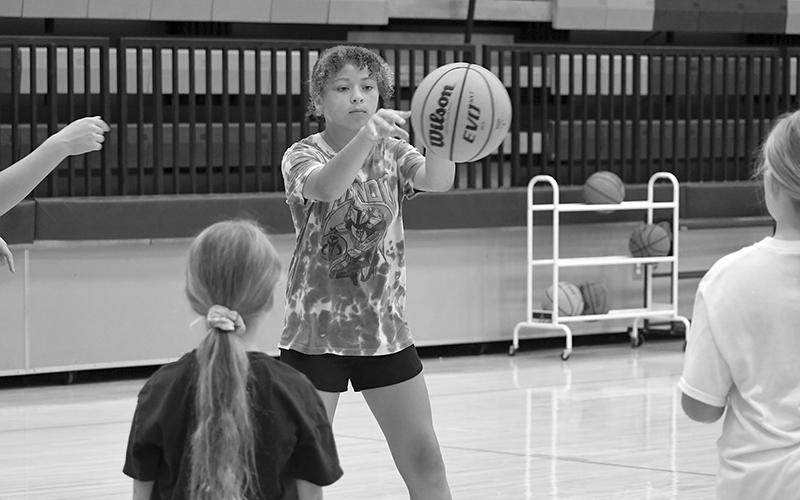 Camper Maya White releases a chest pass during camp on Monday. LANG STOREY/Staff